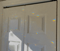 a white door with a reflection of a rainbow