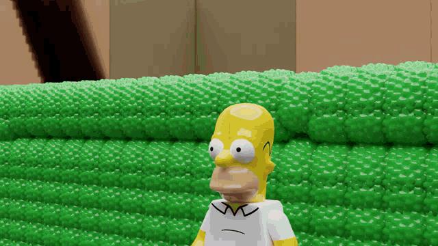 homer simpson standing in front of a green wall