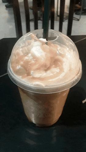 a cup of coffee with whipped cream on top