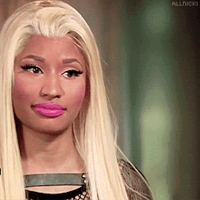 a close up of a woman 's face with the word allnicki on the bottom