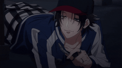 a man in a baseball cap is laying on the floor