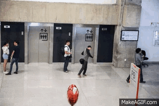 a group of people are standing in front of elevators and a sign that says pr