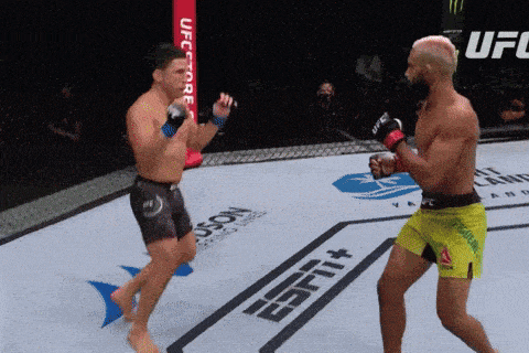 two men are fighting in a boxing ring that has espn on the floor