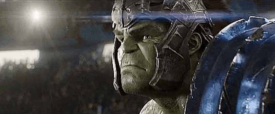 a close up of a man wearing a helmet and armor in a stadium .