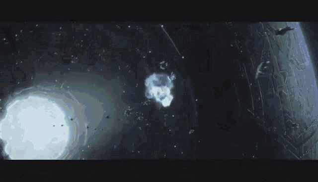 a man in a helmet is looking out a window at a group of spaceships flying in the sky .