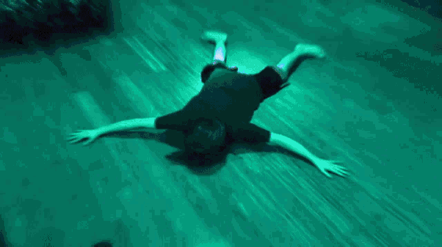 a person is laying on their back on a blue surface