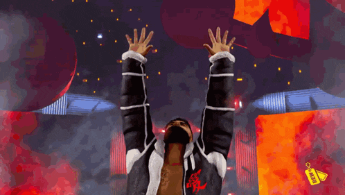 a man in a black and white jacket with a red logo on the front is raising his arms in the air