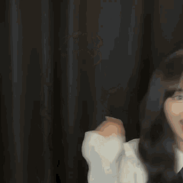 a woman wearing a white shirt and a blue bow tie is making a funny face