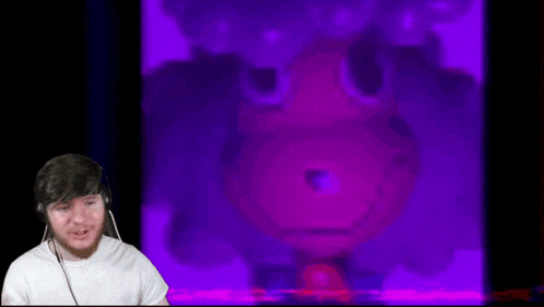 a man wearing headphones looks at a screen that says seek on it
