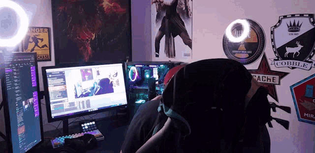 a person sitting in front of a computer with a sticker that says cache