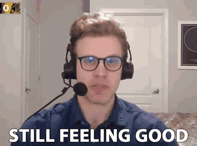 a man wearing glasses and a microphone says still feeling good