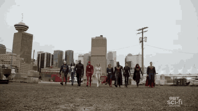 a group of superheroes walking in front of a city skyline