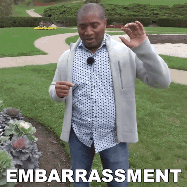 a man standing in a park with the word embarrassment written on the bottom