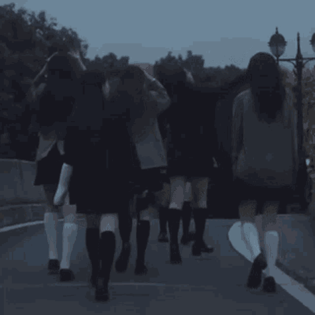 a group of girls walking down a street with socks on