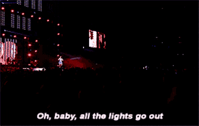 a woman singing in front of a crowd with the words " oh baby all the lights go out "