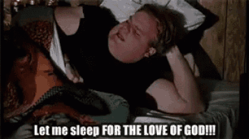 a man is laying on a bed with the words `` let me sleep for the love of god '' written next to him .
