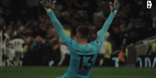 a soccer player with the number 13 on his jersey is celebrating