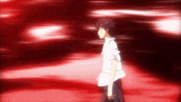 a man in a white shirt is walking in a dark room