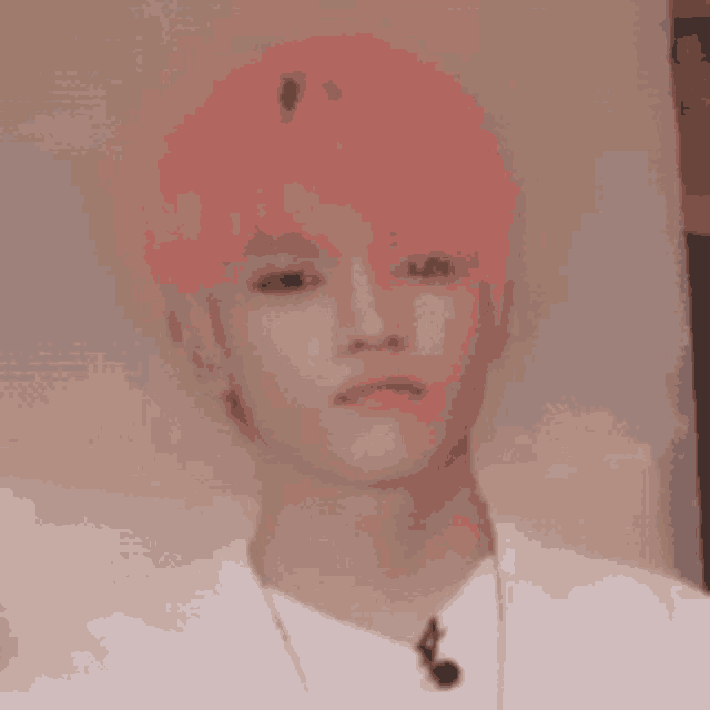 a close up of a person with pink hair wearing a white shirt .