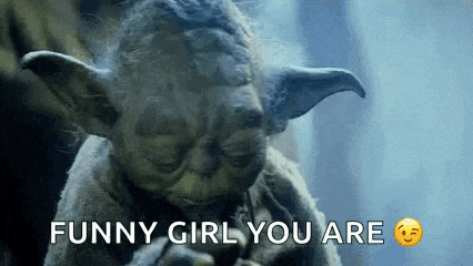 a close up of a statue of yoda with the words `` funny girl you are '' written on it .