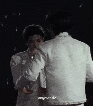 two men in white jackets are hugging each other with a caption that says ' ongebebsie ' on the bottom