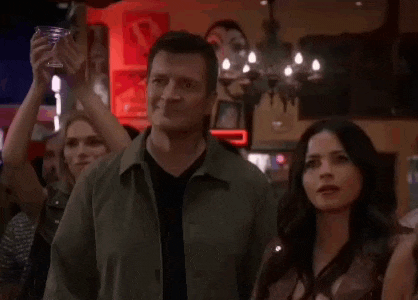 a man and a woman are standing in a bar .