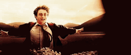 a man in a suit and tie is running in a field with his arms outstretched