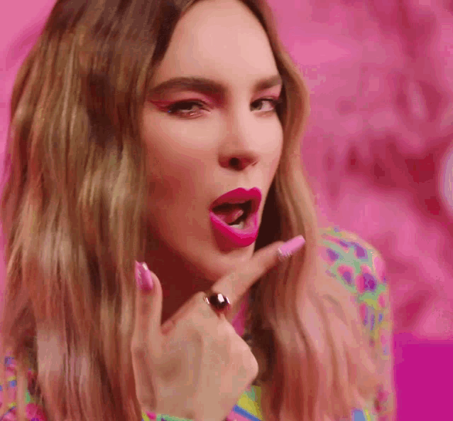 a close up of a woman 's face with pink lipstick and a ring on her finger