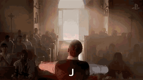 a man is standing in front of a crowd of people in a church and giving a speech .