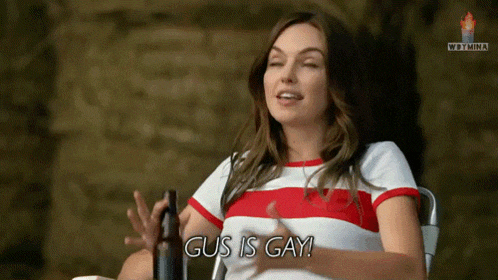 a woman says gus is gay while holding a beer bottle