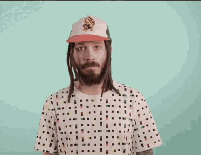 a man with dreadlocks is wearing a hat that says turtle on it