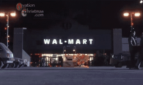 a man in a hoodie stands in front of a walmart