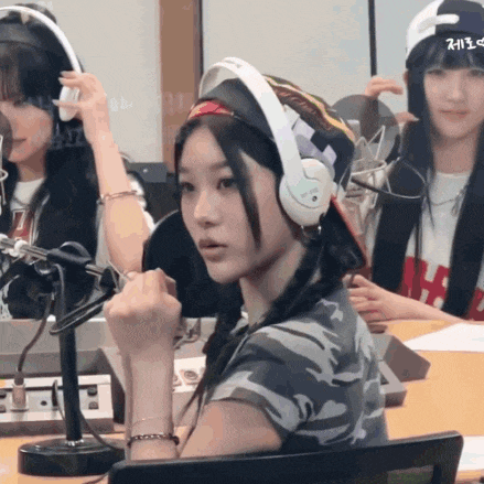 a girl wearing headphones and a hat that says ' 2013 ' on it