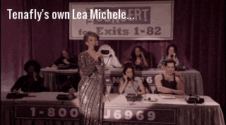 a woman singing in front of a sign which says tenafly 's own lea michele