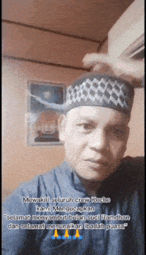a man wearing a black and white checkered hat says mewakili seluruh crew keche kami mengucapkan