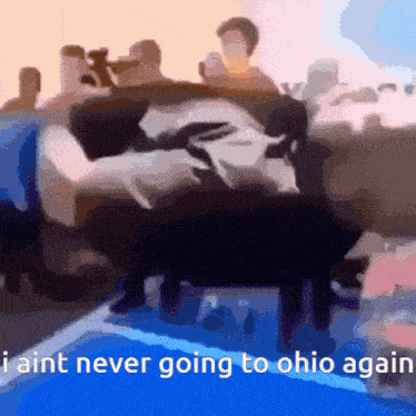 a group of people sitting on a couch with the words " i ain t never going to ohio again "