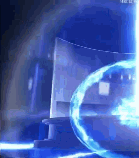 a blue light is coming out of a glass container in a dark room .