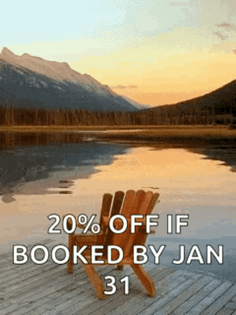 a chair sits on a dock near a lake with mountains in the background .
