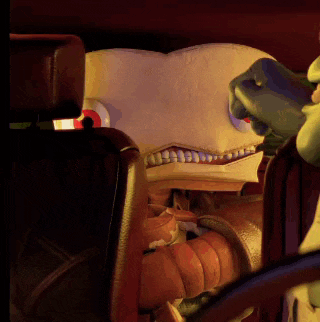 a cartoon character is sitting in a car with a pumpkin in its mouth
