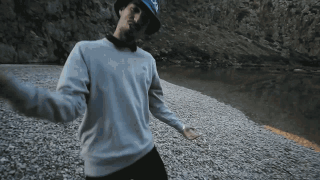 a man wearing a hat and a sweater with the north face on it