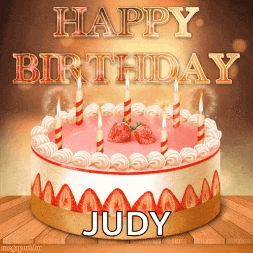 a birthday cake with strawberries and candles and the name judy