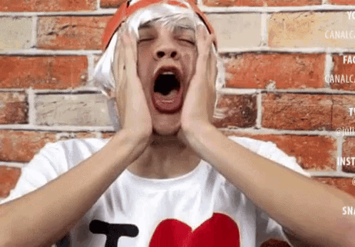 a man wearing a wig and a hat yawning with his mouth open