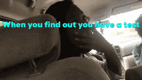 a woman sitting in the back seat of a car with the words when you find out you have a test