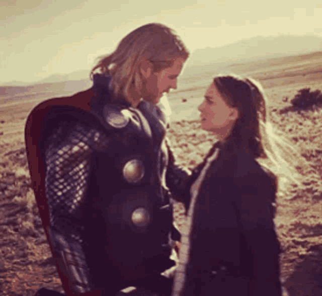a man and a woman are looking at each other