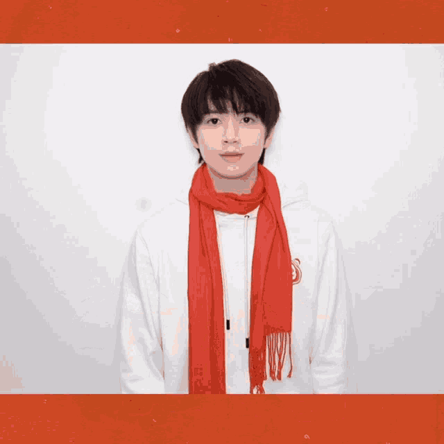 a man wearing a white sweatshirt and a red scarf
