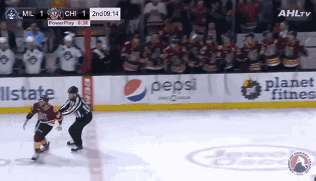 a hockey game is being played in front of a pepsi banner