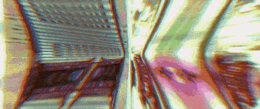 a blurry picture of a tunnel with a purple light coming out of the end