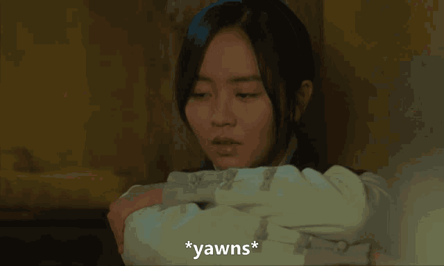 a woman with her eyes closed and the word yawns on the bottom
