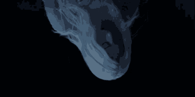 a woman with white hair is upside down with her mouth open