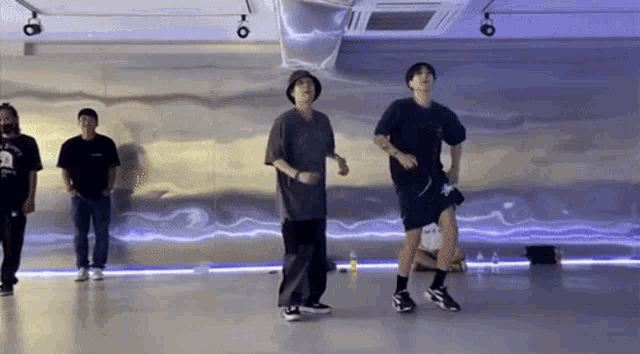 a group of people are dancing in a dance studio .